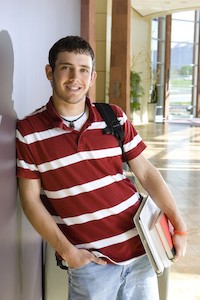 smiling boy leans against hall