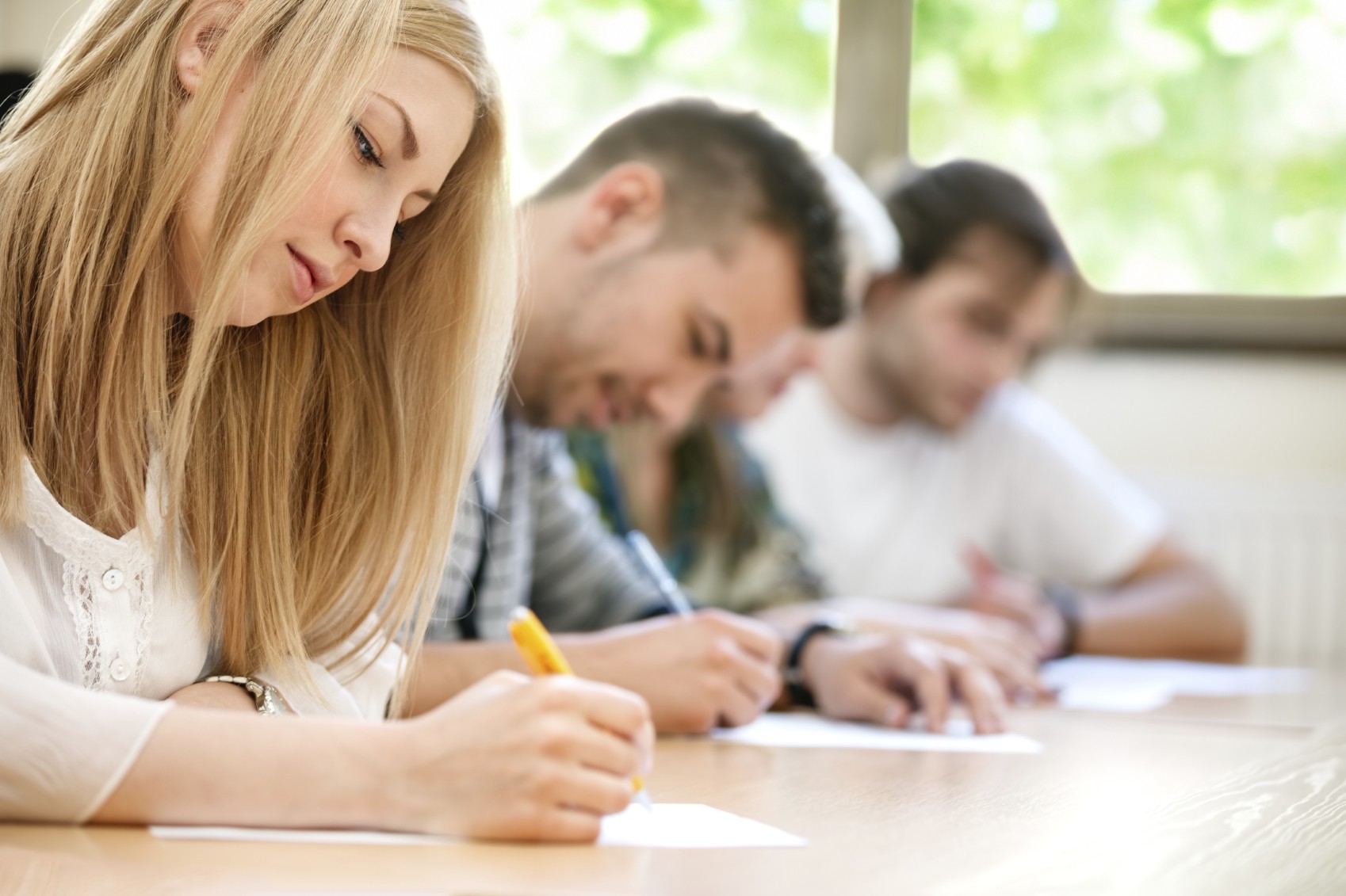 Teen girl taking test in class.