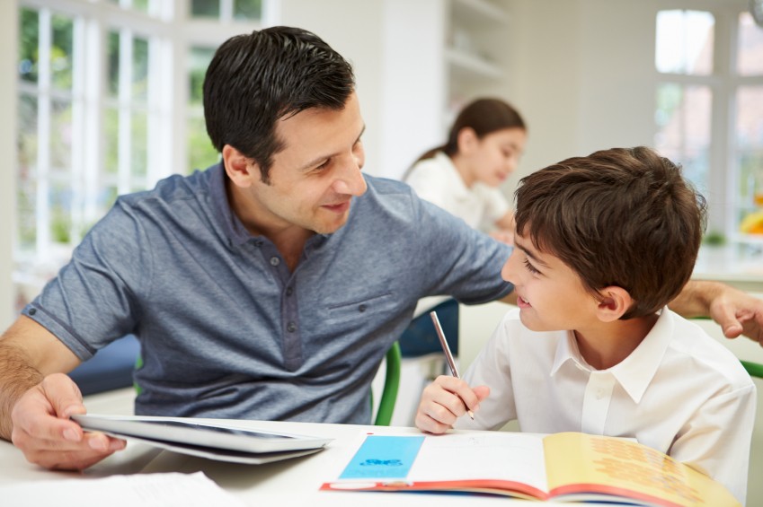 teacher helping girl learn to read