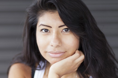 serious brown eyed woman facing reader