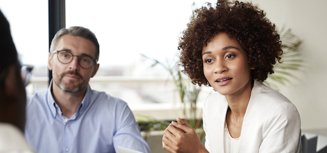 woman asking questions in a meeting