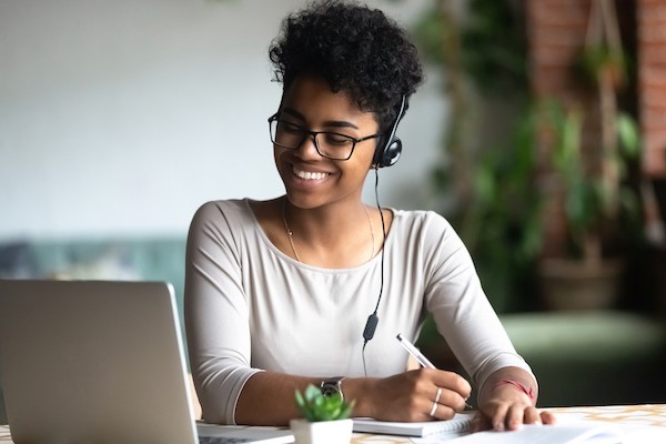 smiling woman viewing cheromputer screen