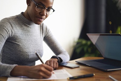 woman writing in a log