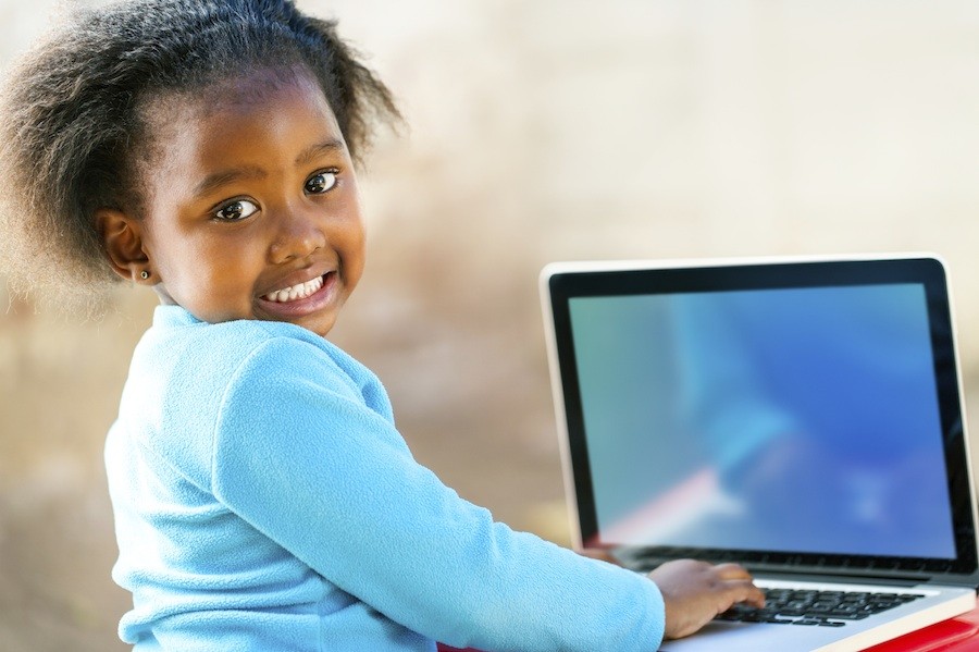 young girl in school on computer