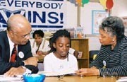 Dr. Paige, Claudia Gaines and 4th grader Chantice Smith during a reading session 